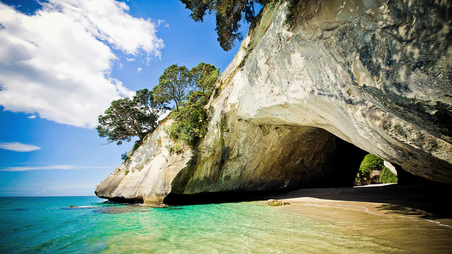 Coromandel Cathedral Cove beach with cliffs, a hotspot for eco-tourism and local businesses.