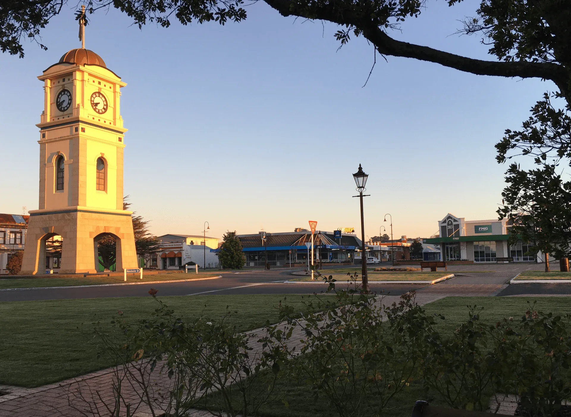 Feilding clock tower at sunrise, showcasing local retail and business in the CBD.