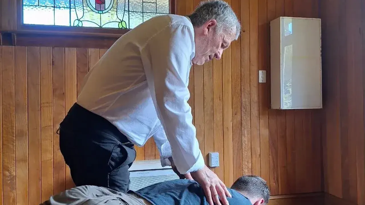 Chiropractor adjusting thoracic spine