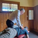 Chiropractor adjusting thoracic spine