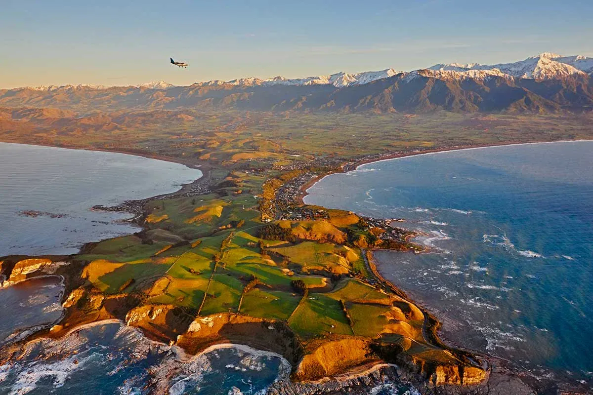 Kaikoura aerial view of mountains and coastline, popular for tourism and marine-based businesses.