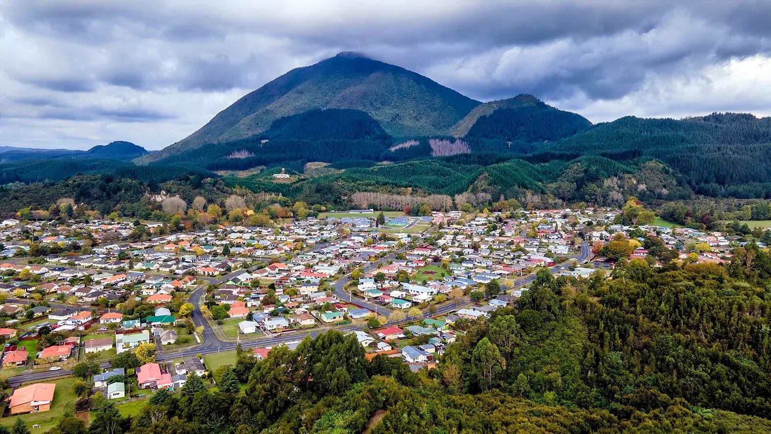 Kawerau town nestled by hills, supporting forestry, manufacturing, and local services.