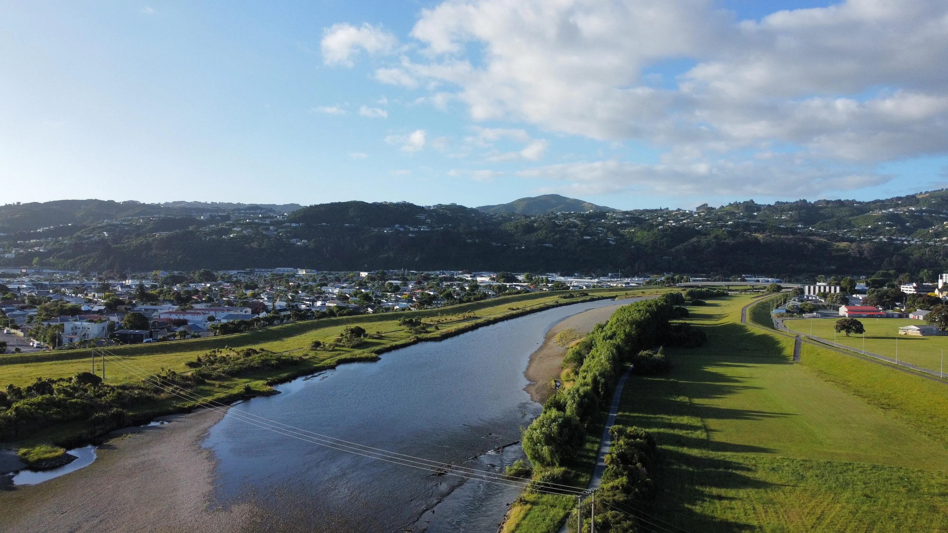 Aerial view of Lower Hutt with Hutt River winding through green fields and hills.