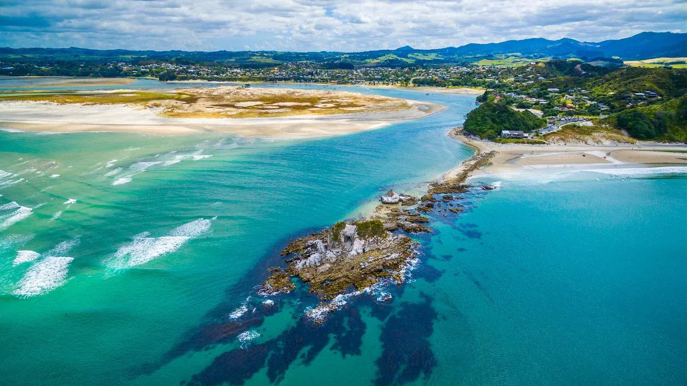 Mangawhai Heads beach and estuary with turquoise water and surf, Northland, New Zealand.