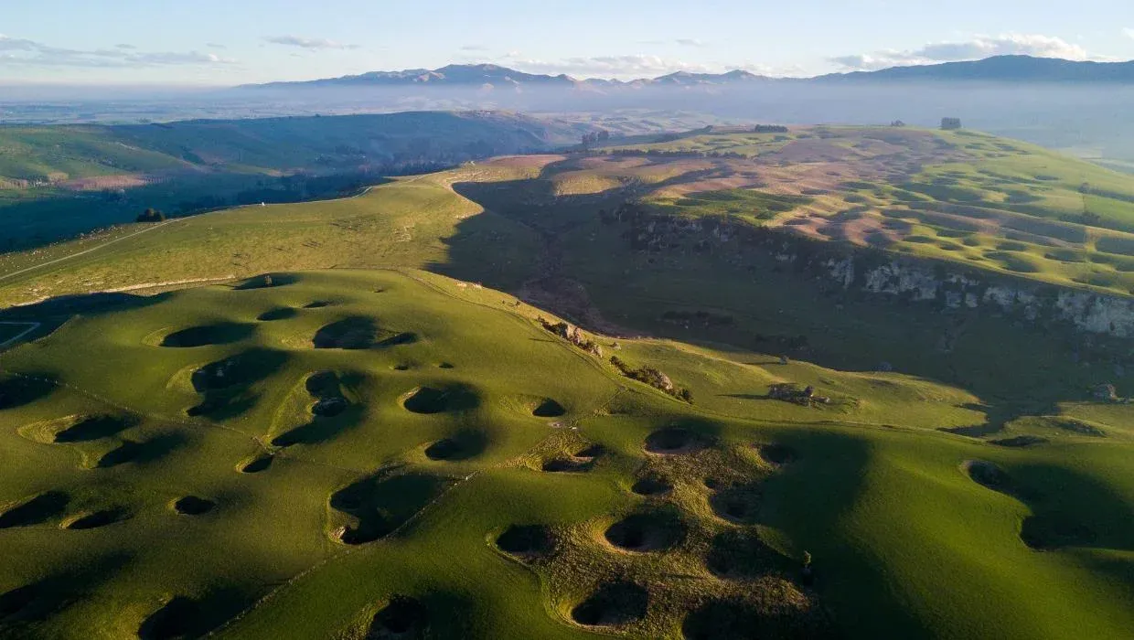 Limestone hills and rolling green fields near Maungati, a picturesque rural Canterbury settlement.