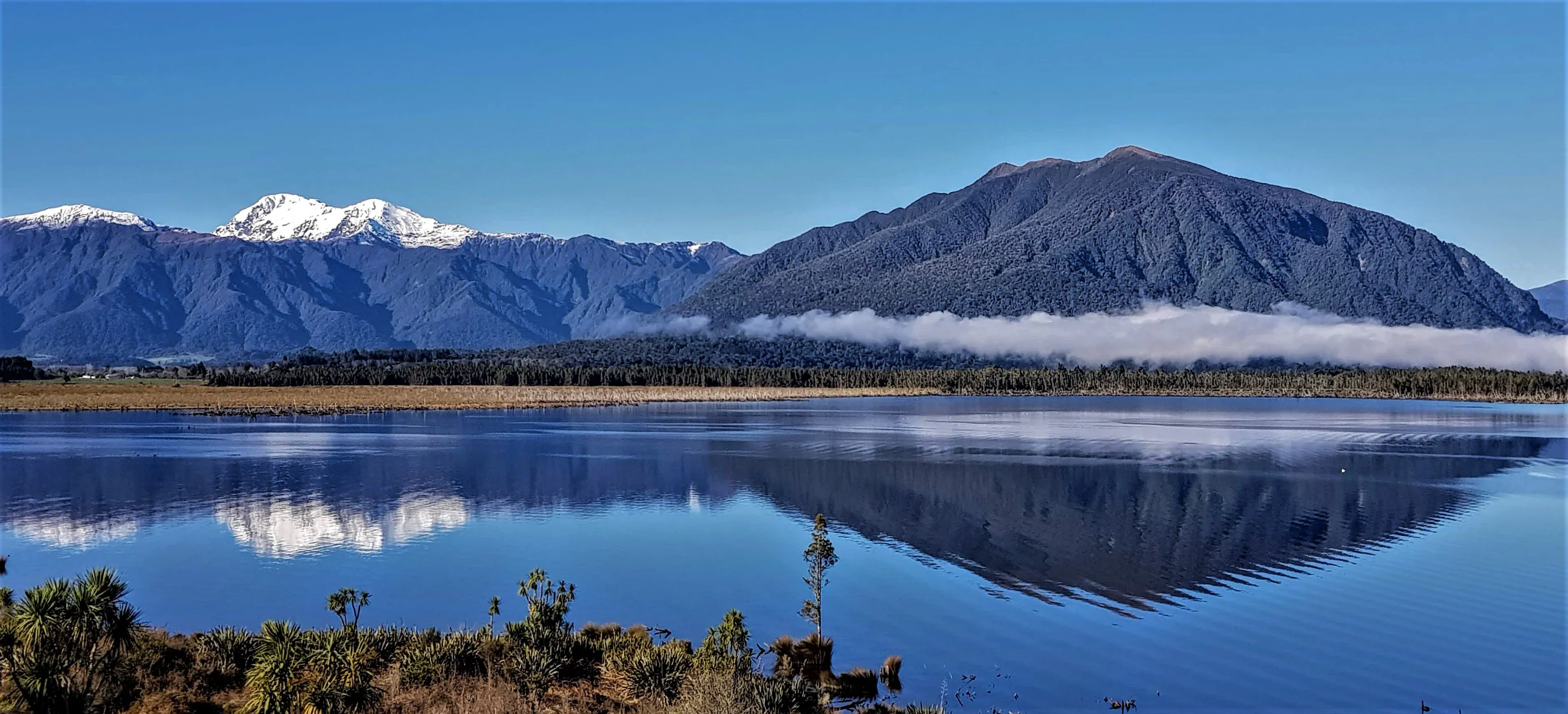 Moana's serene lake and snow-capped mountains, ideal for tourism and outdoor activities.