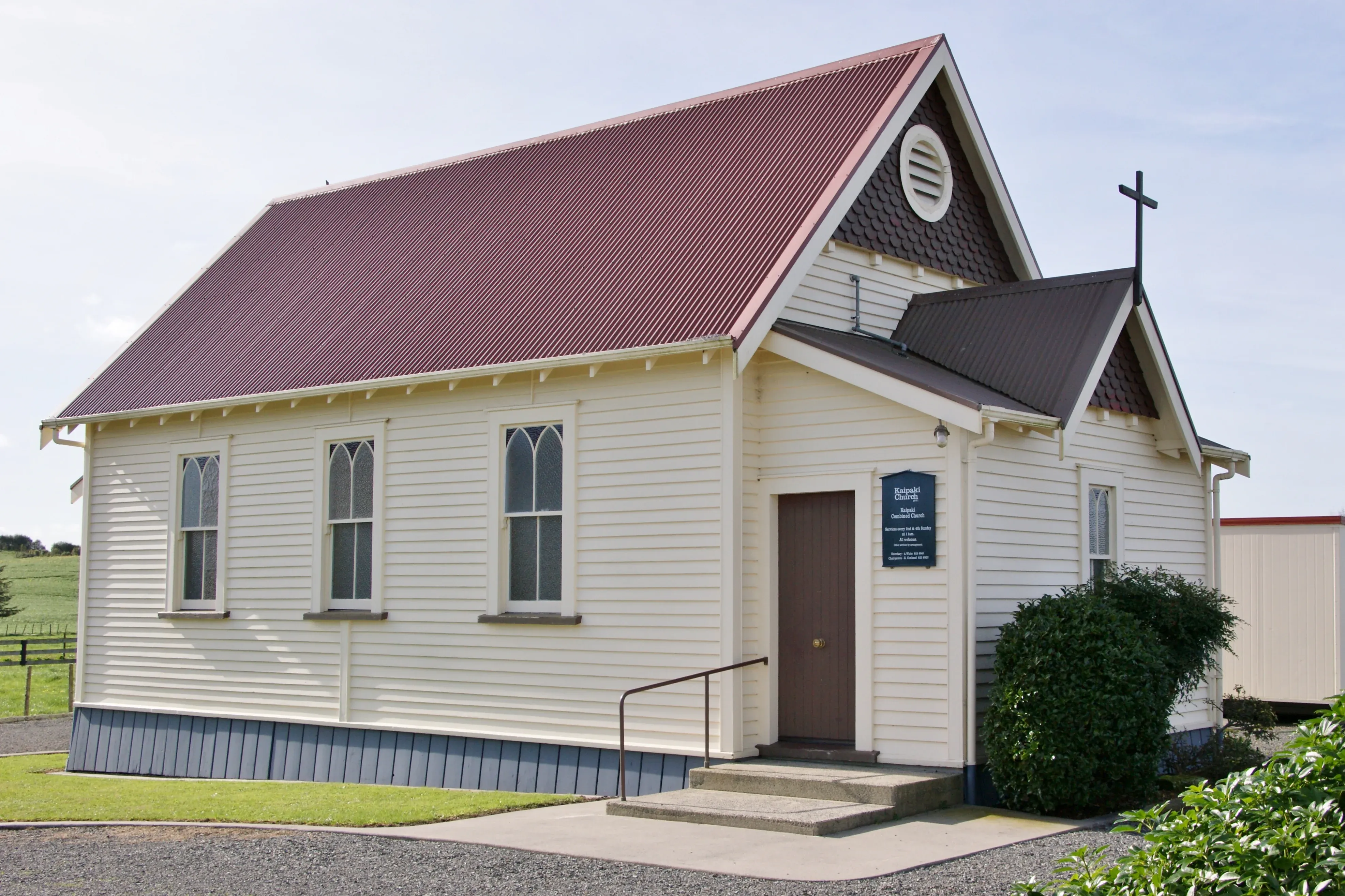 A quaint white chapel with a red roof in Ohaupo, reflecting the area's historical and community values.